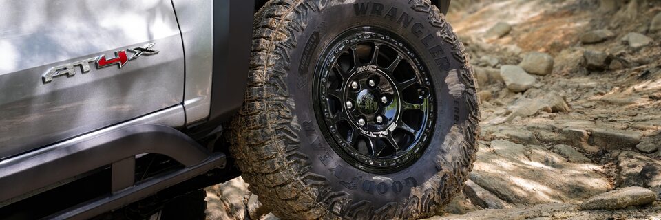 Close-up of the Canyon AT4X AEV Edition's Tire Covered in Mudd