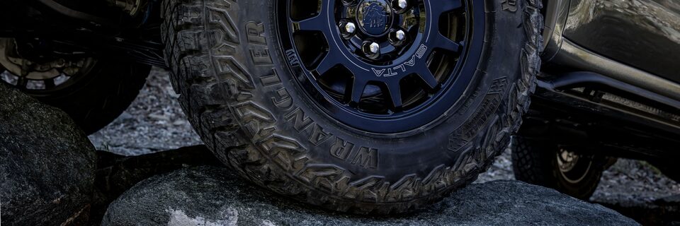 Close-up of the GMC Sierra AT4X Off-Road Truck Tires Covered in Dirt