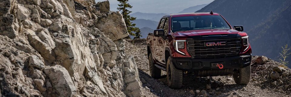 The GMC Sierra AT4X Truck Driving Off-Road Through the Mountains