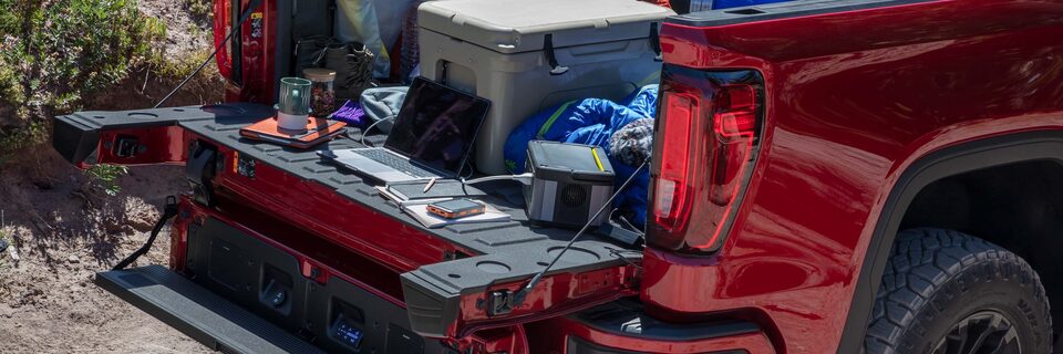 A View of the Interior Storage Space with a Pair of Glasses inside and coins on a GMC Vehicle