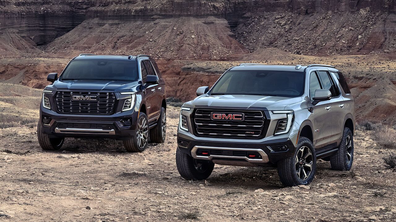 The GMC Yukon and Yukon XL Large SUVs Parked Side by Side in a Desert Canyon