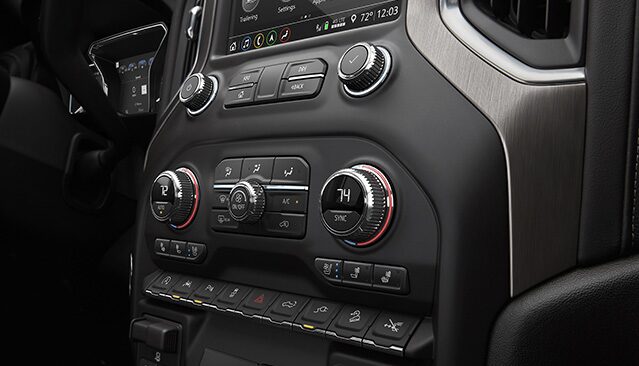 A Close-up of the Climate Control and Media Buttons on the Dashboard of a GMC Vehicle Interior