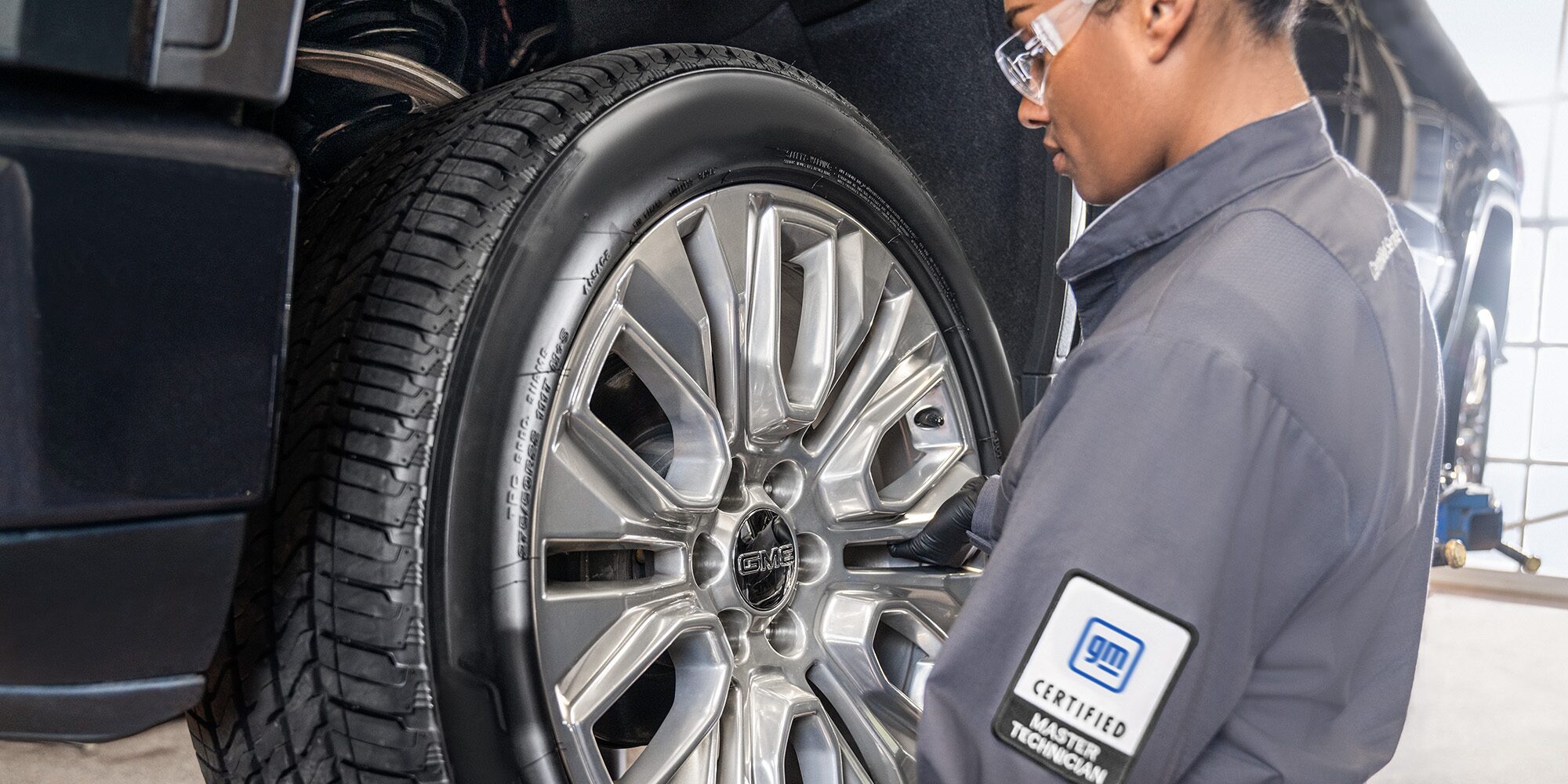 A Mechanic Observing the Tire of a GM Vehicle
