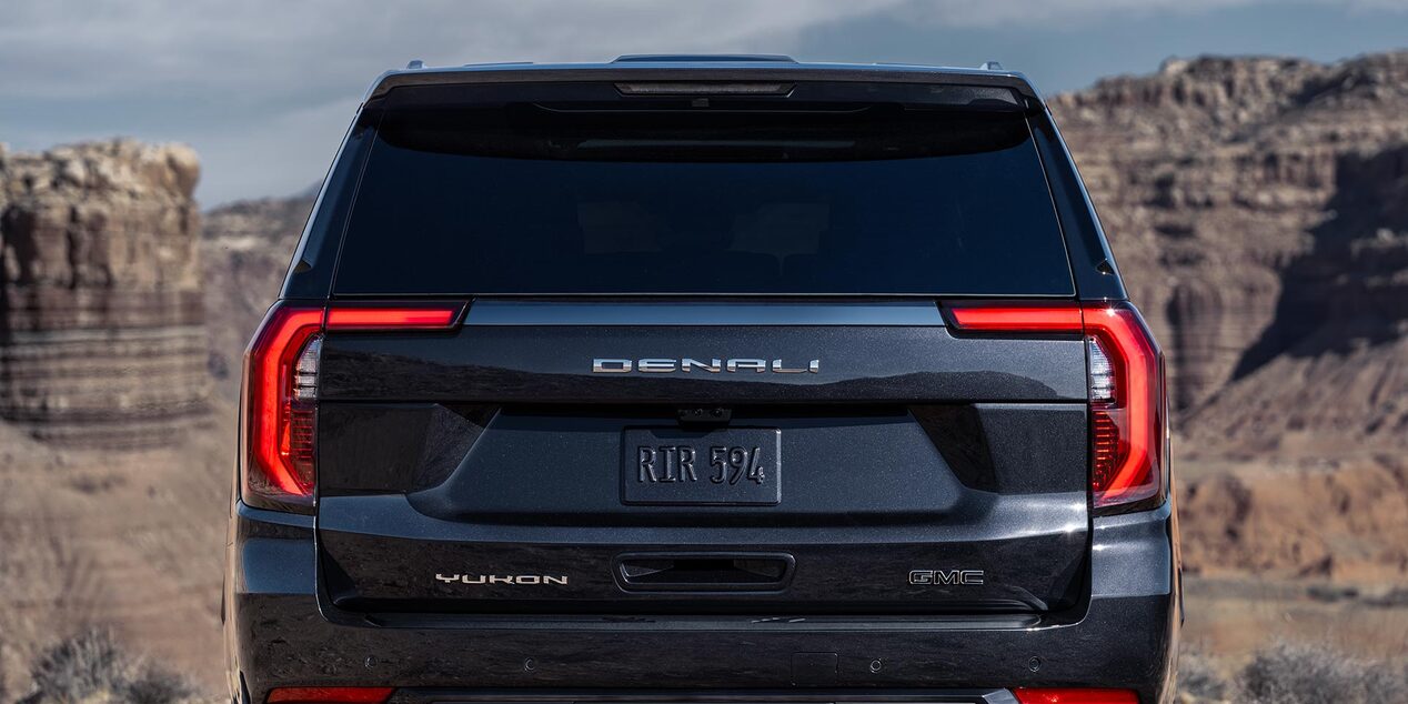 Rear View of the GMC Yukon Large SUV with Desert Rocks in the Distance
