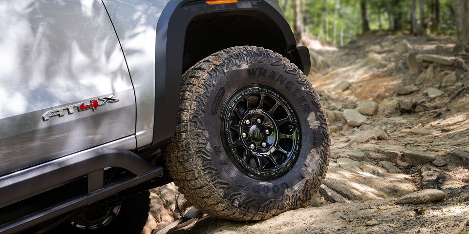 Close-up of the 2025 GMC Canyon AT4 Tires While Off-roading on a Rocky Path