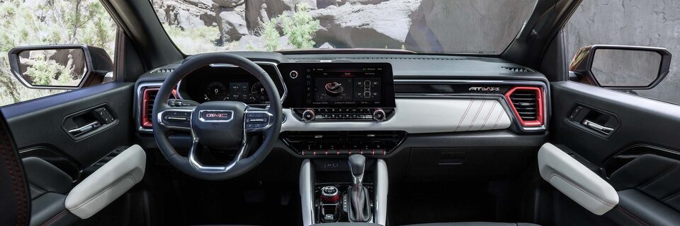 The 2025 GMC Canyon AT4 Front Interior with Steering Wheel and Infotainment System