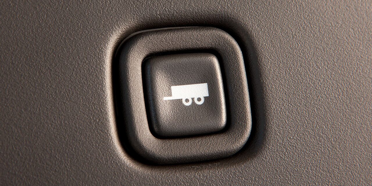 Close-up of the Towing and Hauling Mode Button in a 2026 GMC Savana Cargo Van