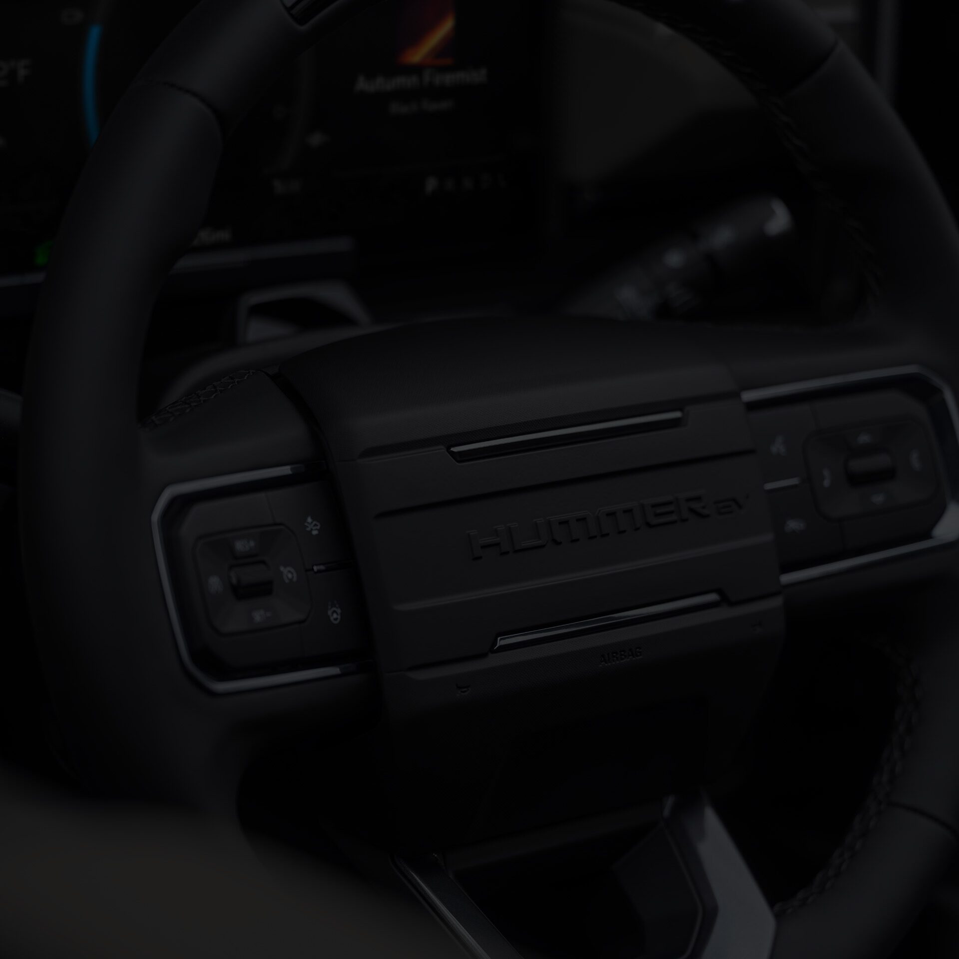 Close-up of the 2026 HUMMER EV Pickup Truck All-black Steering Wheel