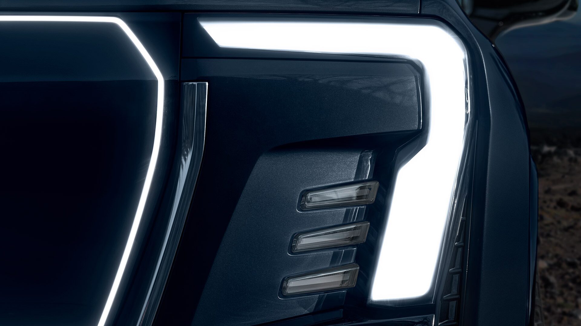 Close-up Exterior View of the 2026 GMC Sierra EV Denali Front Headlamps
