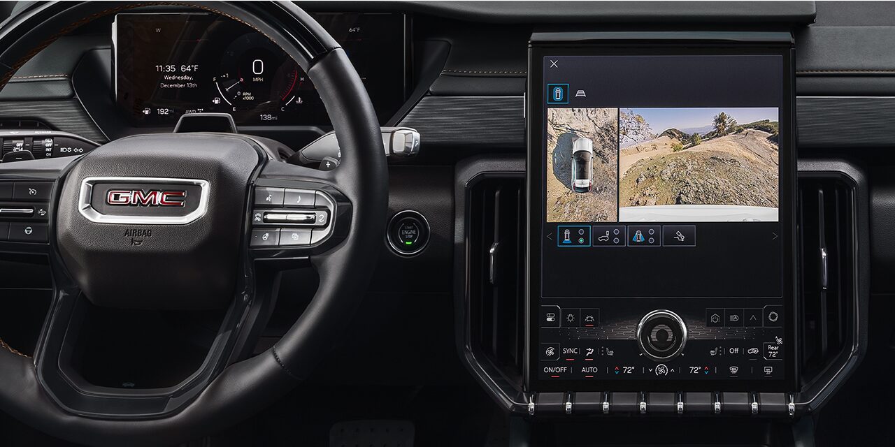 Interior View of the Steering Wheel and Infotainment System in the 2026 GMC Acadia