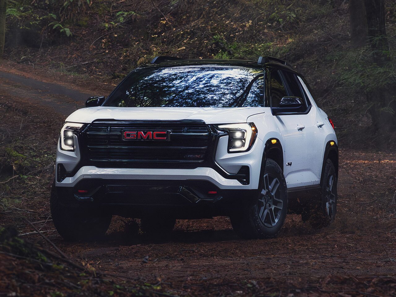 View of the 2026 GMC Terrain AT4 Small Off-Road SUV Parked in the Woods