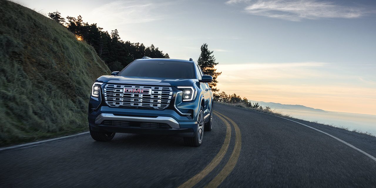 The GMC Terrain Small SUV Driving Down a Winding Road Along the Coast Line