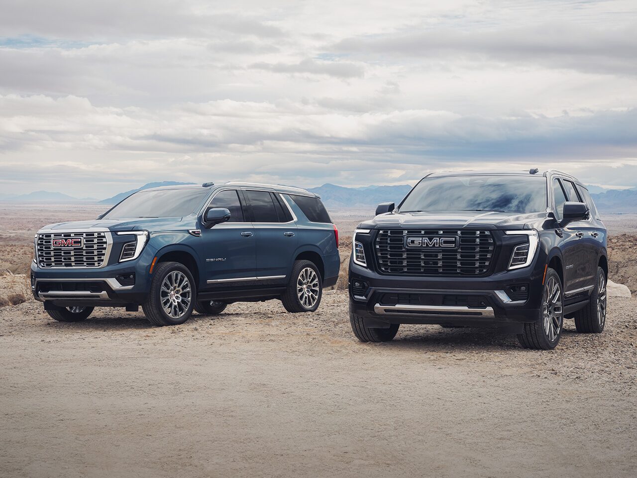 The 2026 GMC Yukon Denali and Denali Ultimate Luxury SUVs Parked Next to Each other on a Beach