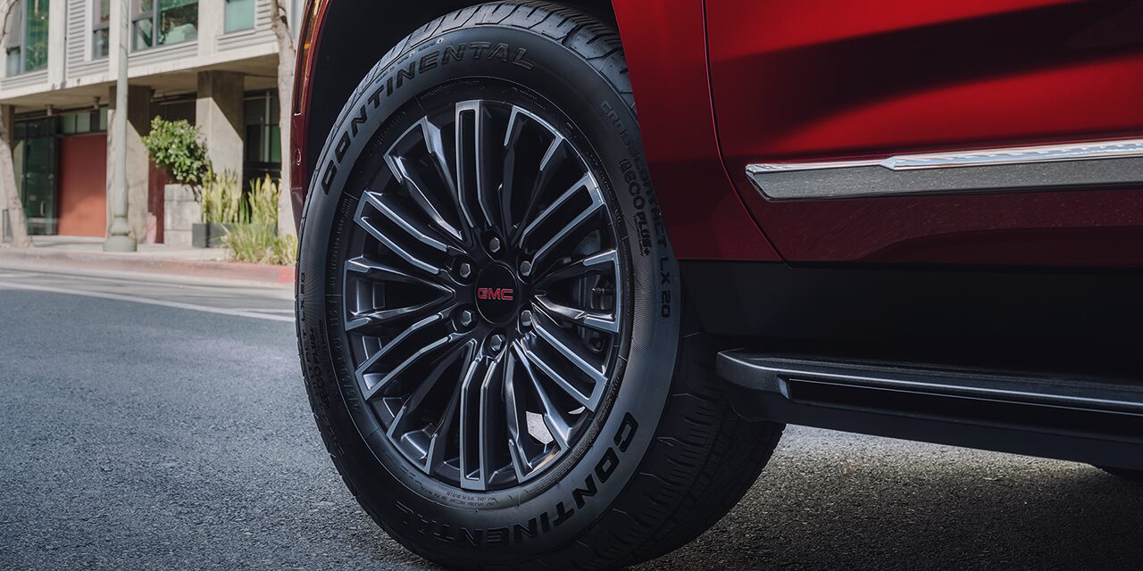 20" Wheels on a 2026 Yukon Elevation Full-Size SUV Driving Down a Street