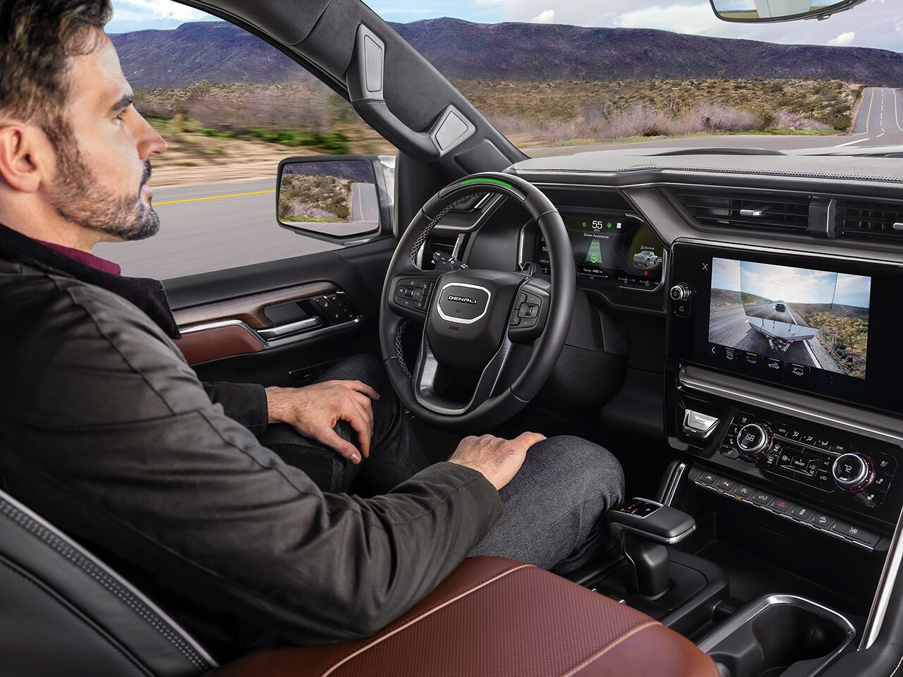 Profile View of a Name Driving the 2026 GMC Sierra 1500 Pickup Truck Using the Super Cruise Hands-Free Driving Technology