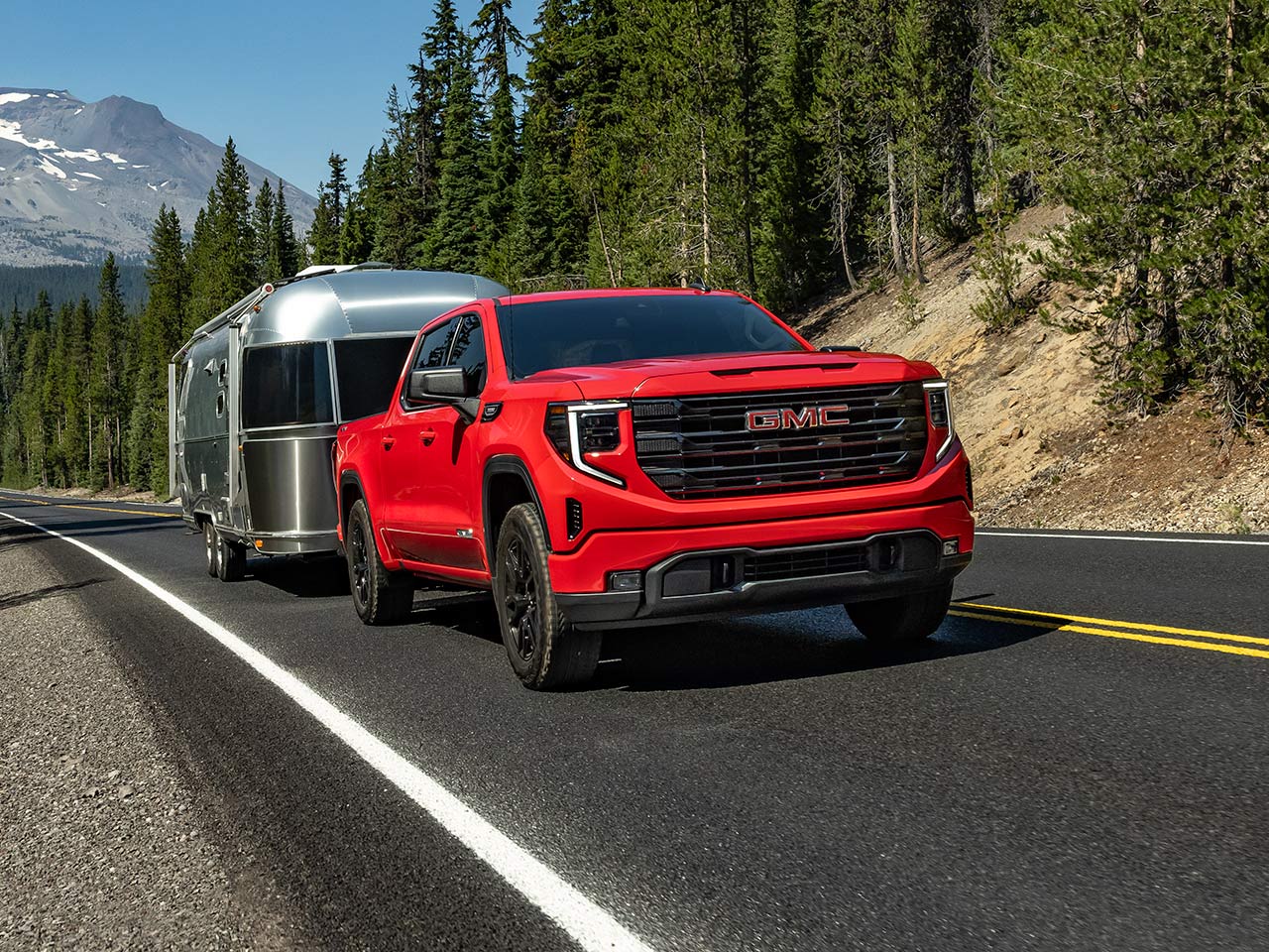 The 2026 GMC Sierra 1500 Pickup Truck Towing a Trailer Down the Open Road